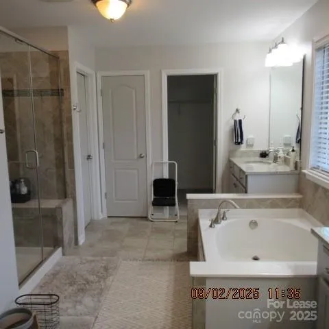 a view of a bathroom with a tub and mirror