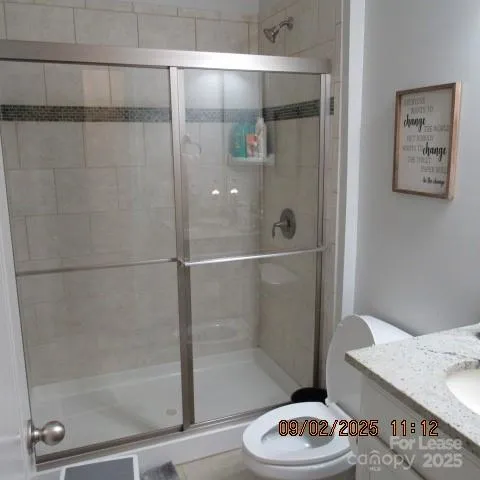 a bathroom with a shower and a sink