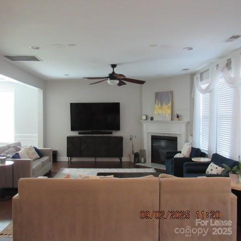 7314 Vesper Drive Huntersville, NC 28078 - Photo 8 of 24 a living room with furniture a flat screen tv and a fireplace