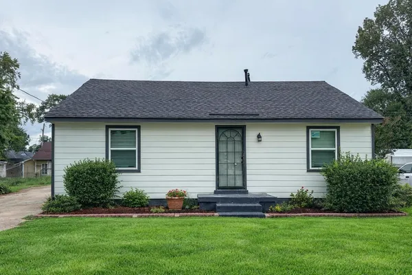 a front view of a house with a garden