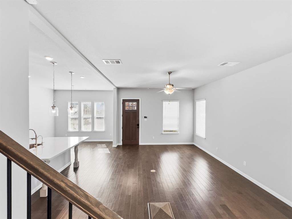 12632 Akenside Road Frisco, TX 75035 - Photo 11 of 40 a view of an empty room with wooden floor and a window