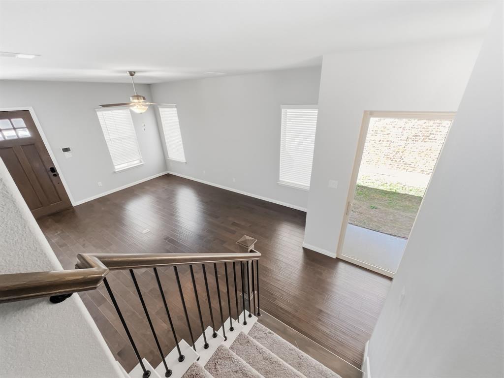 12632 Akenside Road Frisco, TX 75035 - Photo 12 of 40 an empty room with wooden floor and windows