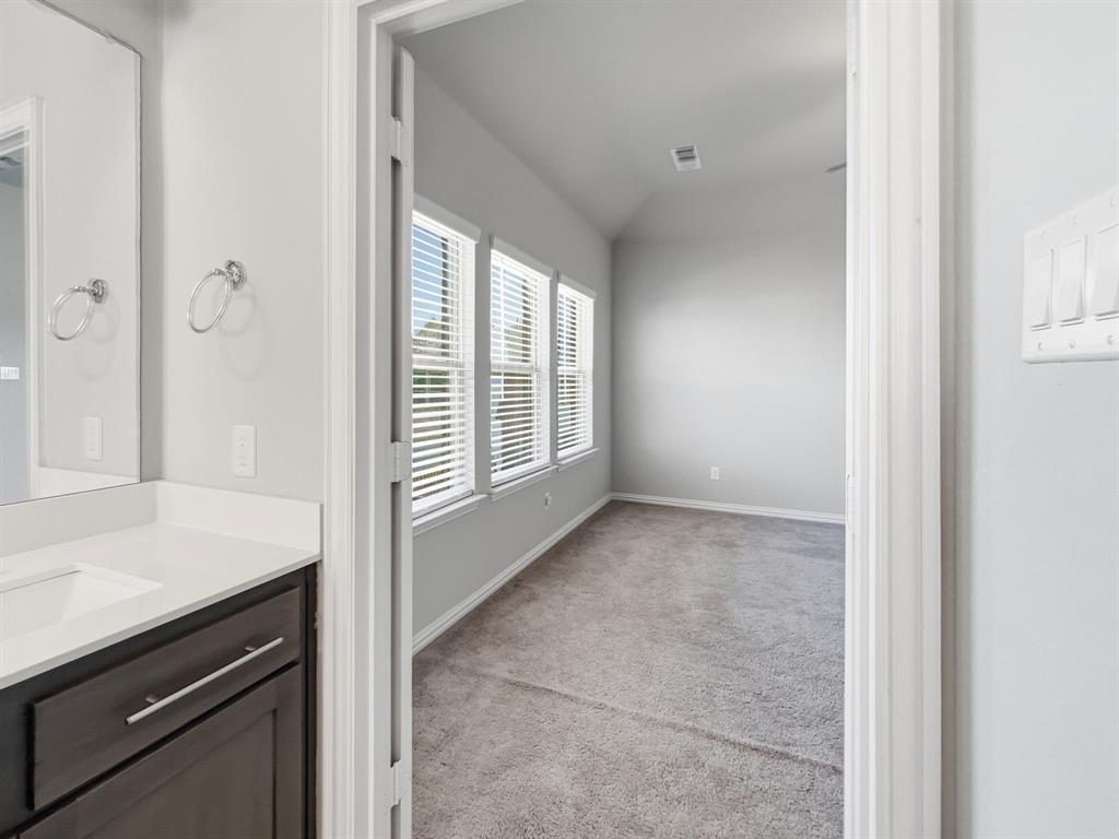12632 Akenside Road Frisco, TX 75035 - Photo 19 of 40 View from the primary bathroom into the adjoining primary bedroom.