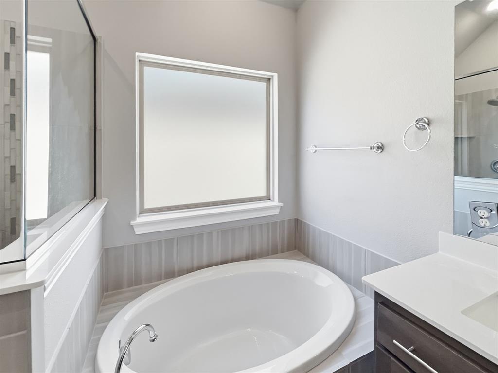 12632 Akenside Road Frisco, TX 75035 - Photo 22 of 40 a white bath tub sitting next to a white sink