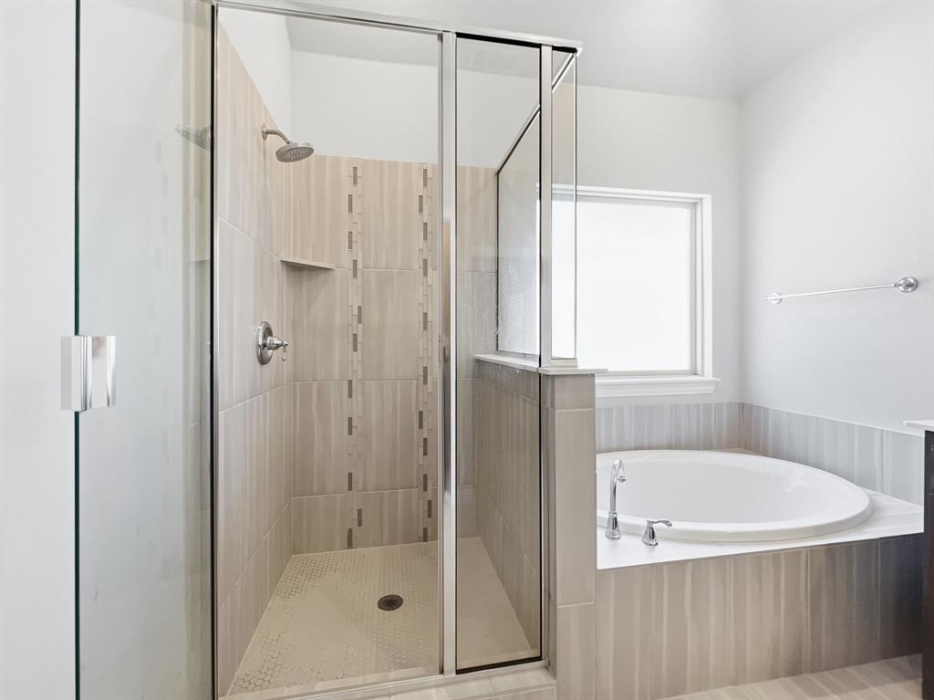 12632 Akenside Road Frisco, TX 75035 - Photo 23 of 40 a bathroom with a bath tub and shower