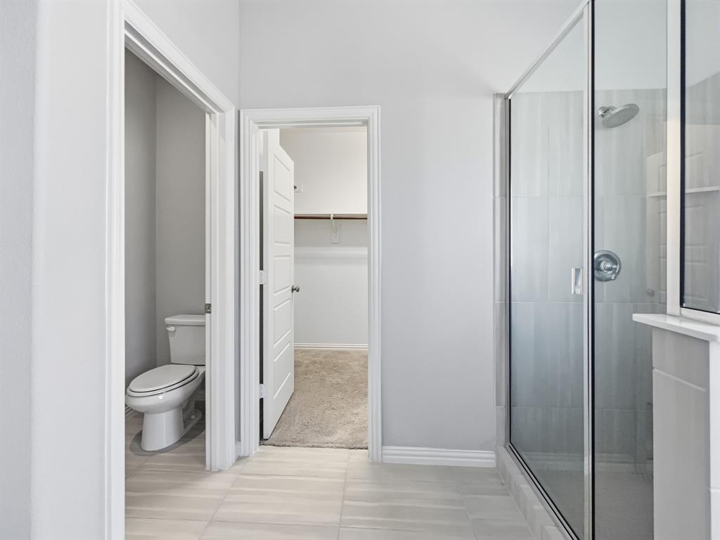 12632 Akenside Road Frisco, TX 75035 - Photo 24 of 40 a bathroom with a shower and a toilet