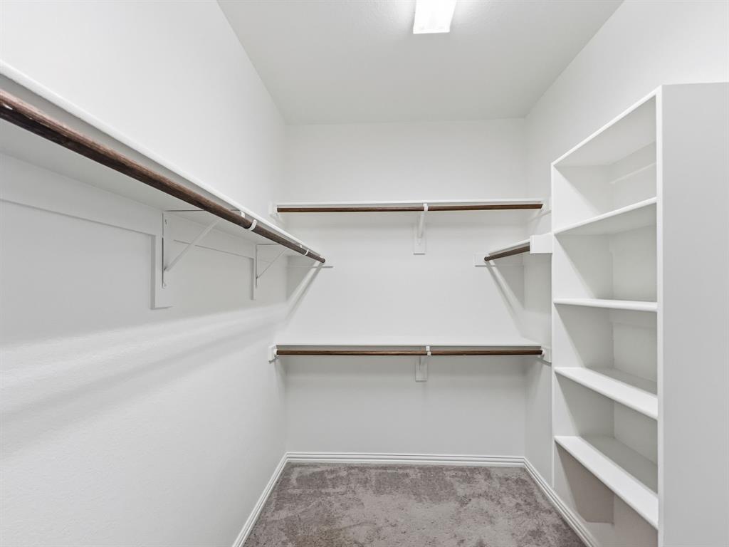 12632 Akenside Road Frisco, TX 75035 - Photo 25 of 40 a view of an empty walk in closet
