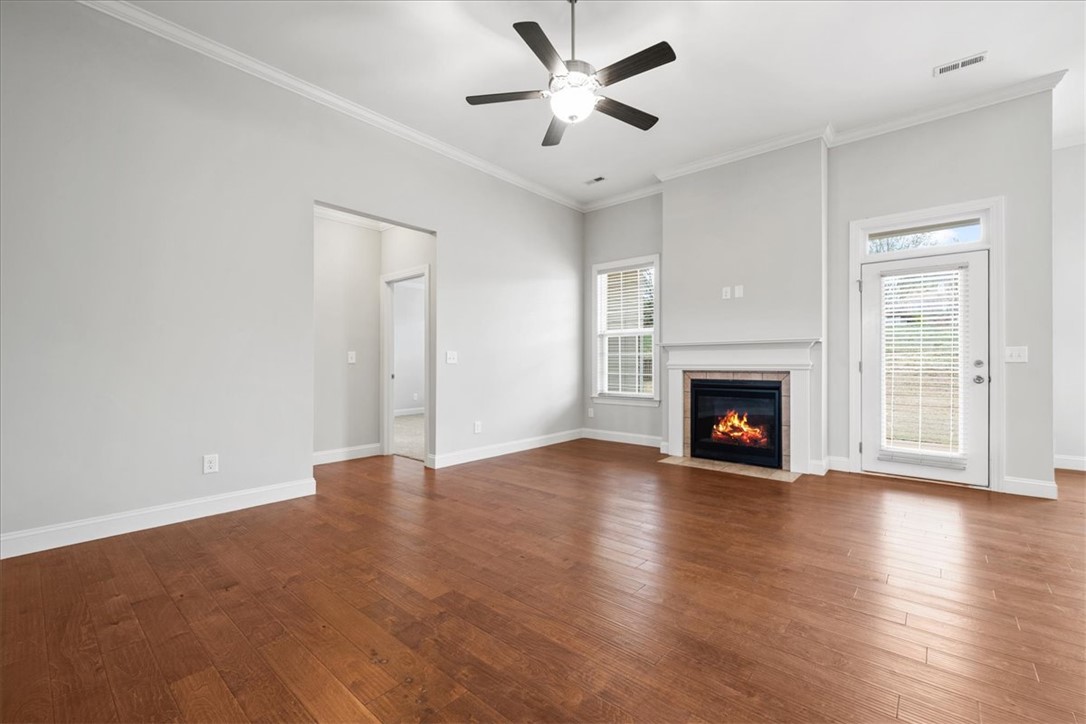 102 Ripplestone Way Anderson, SC 29621 - Photo 4 of 39 An inviting gathering space features warm wood flooring and a cozy fireplace with mantel.