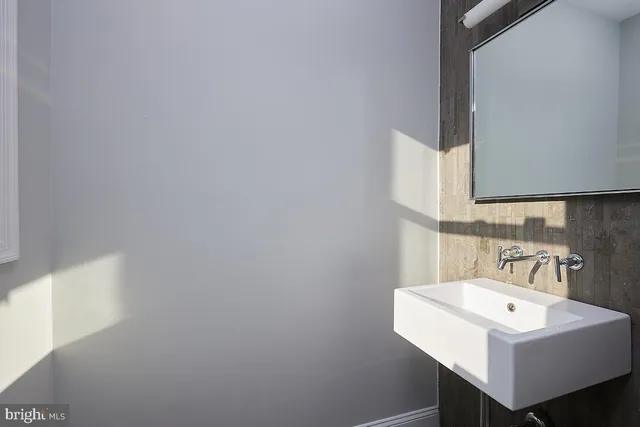 a bathroom with a sink a mirror and a toilet