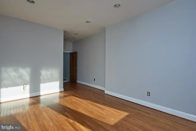 a view of an empty room and wooden floor