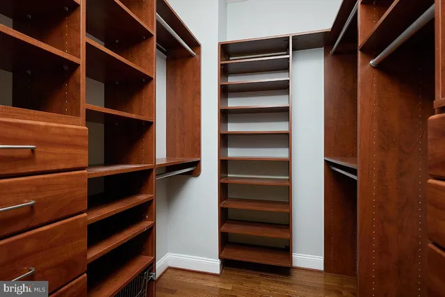 a view of walk in closet with empty racks