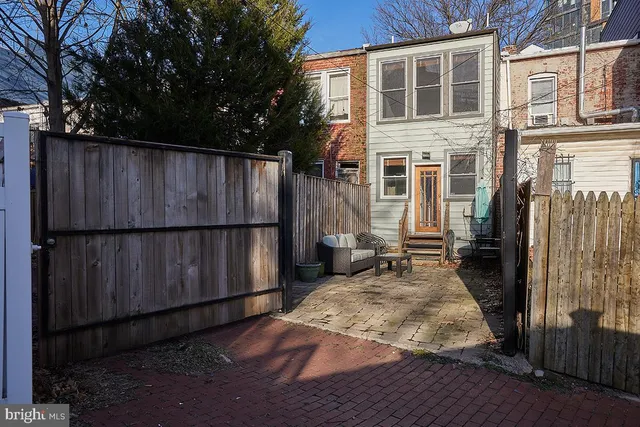 a view of a house with a wooden fence