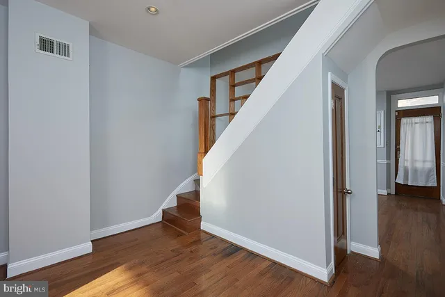 a view of an entryway with wooden floor