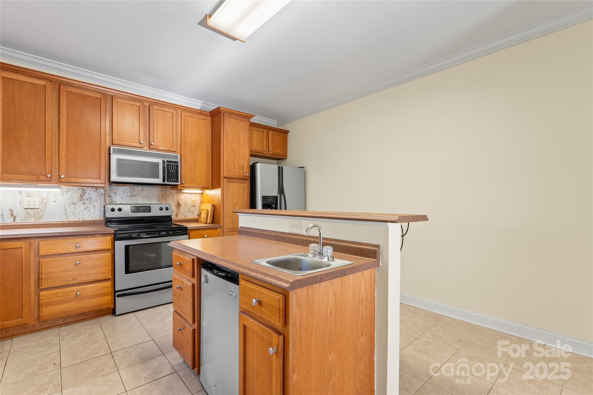 645 Chestnut Ridge Church Road Kings Mountain, NC 28086 - Photo 16 of 45 a kitchen with stainless steel appliances granite countertop a stove a sink and a microwave