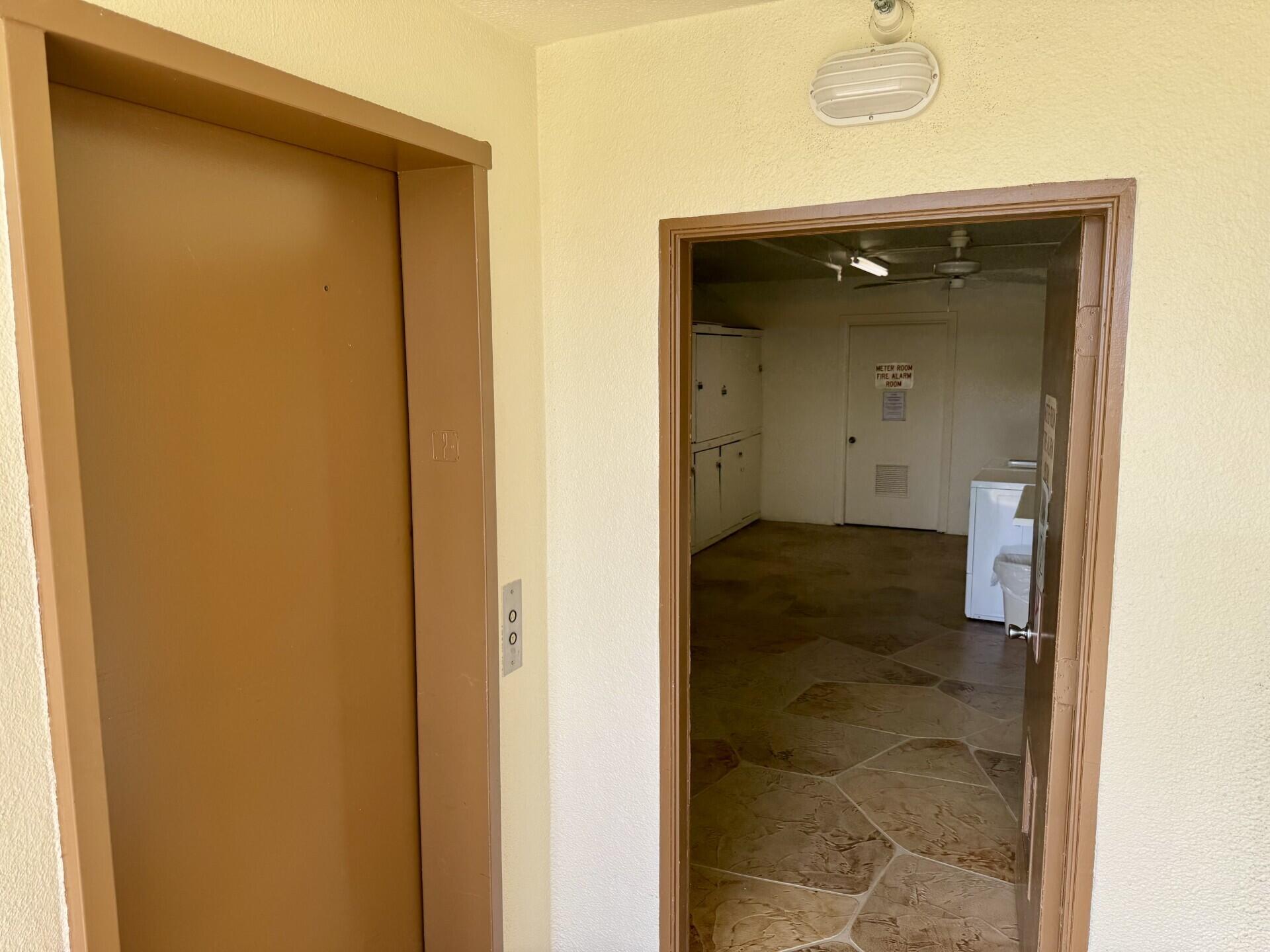 273 Mansfield H, Unit 273 Boca Raton, FL 33434 - Photo 18 of 33 Elevator & Laundry
