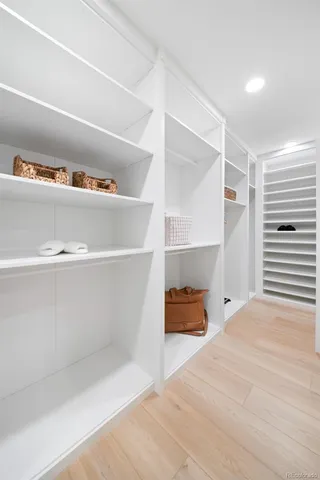 a view of a hallway with wooden floor and dining room
