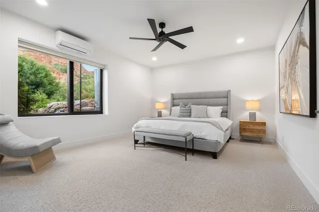 a bedroom with a bed a couch and a painting