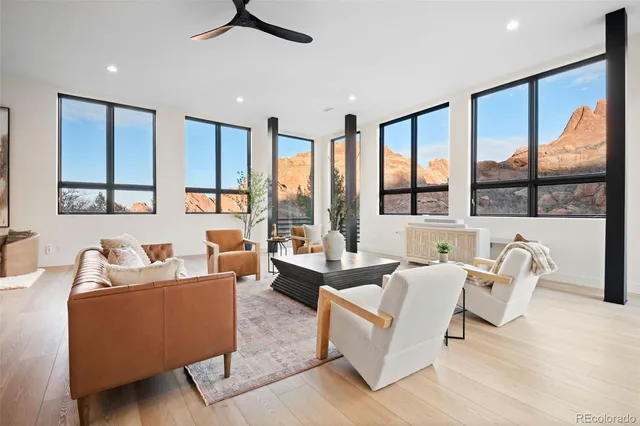 a view of a hallway with furniture and chandelier