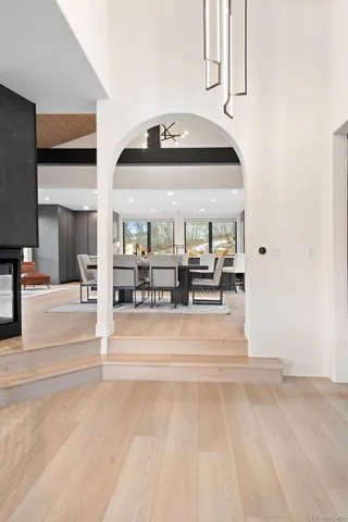 a large white kitchen with a large island in the center