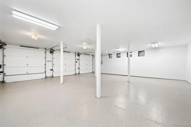 a view of a roof deck with table and chairs a barbeque and potted plants