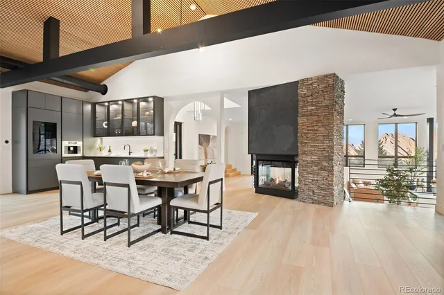 a dining room with furniture and wooden floor