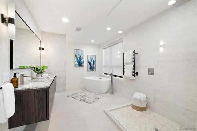 a bathroom with a granite countertop sink mirror and shower