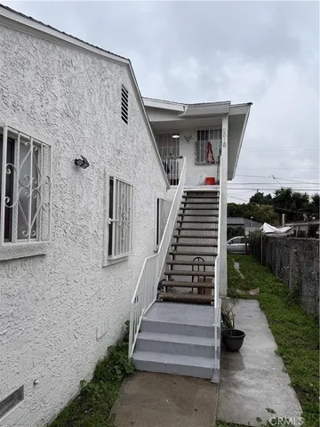 a view of a patio with table and chairs