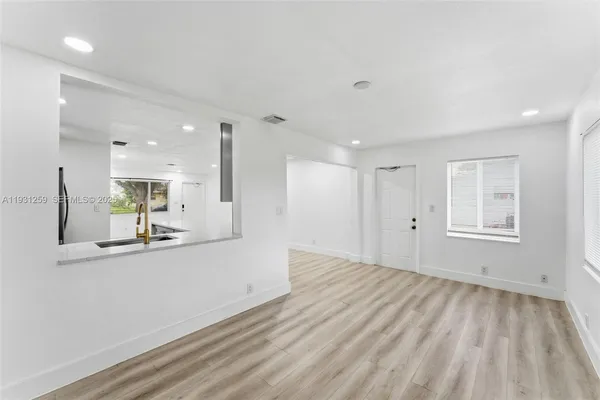a view of a kitchen with a sink and a window