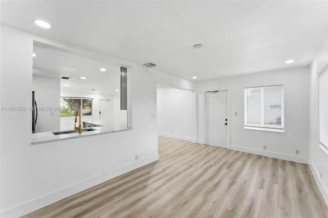 a view of a kitchen with a sink and a window