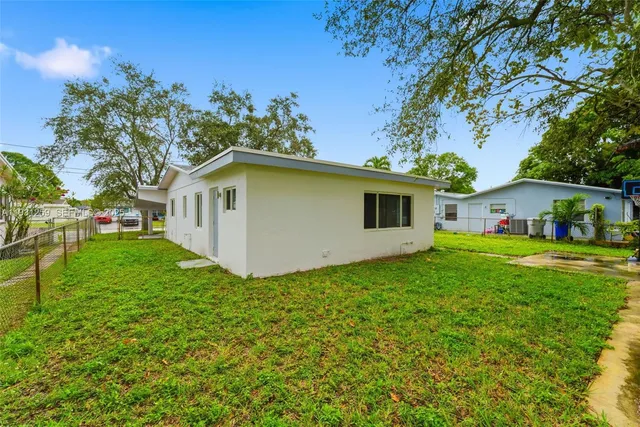 a view of an house with backyard space and garden