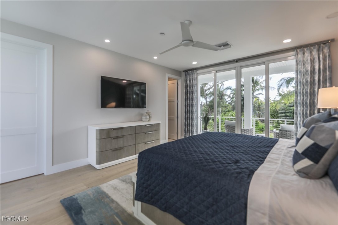 941 South Seas Plantation Road Captiva, FL 33924 - Photo 18 of 50 a bedroom with a bed and a flat screen tv