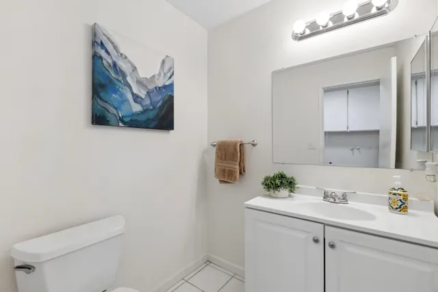 a bathroom with a sink a toilet and mirror