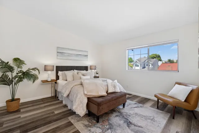 a bed room with a bed and a potted plant