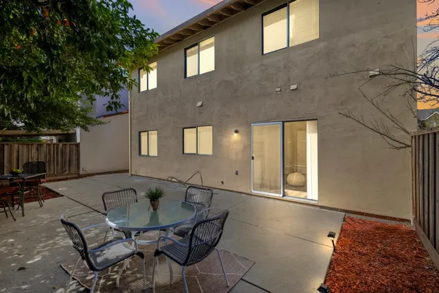 a balcony with table and chairs