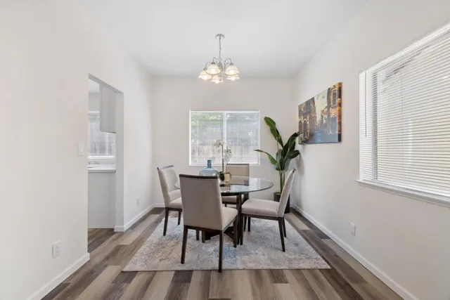 a view of a dining room with furniture window and wooden floor