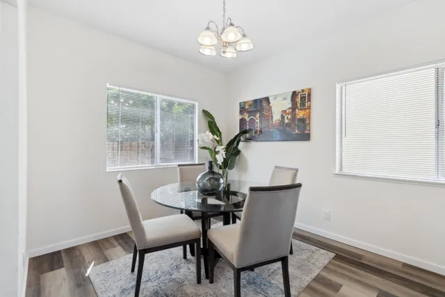 a dining room with furniture a rug and a window