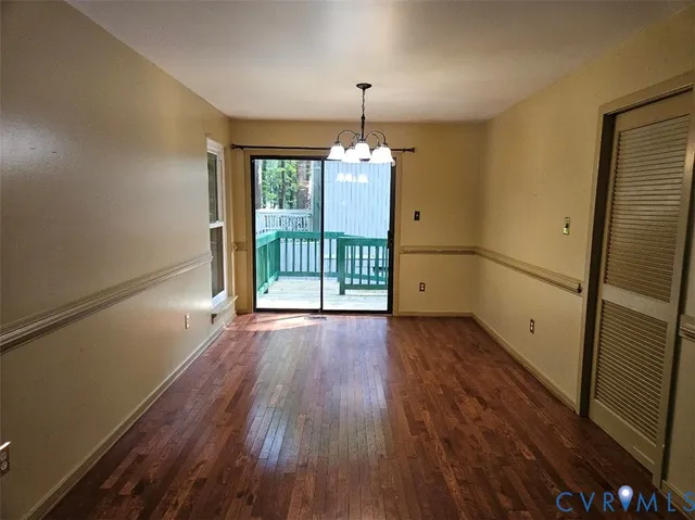 a view of a porch with a floor to ceiling window and wooden fence