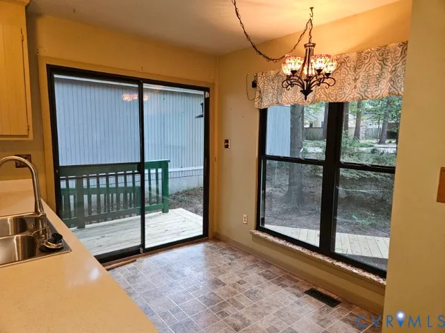 a view of an empty room with a ceiling fan and window