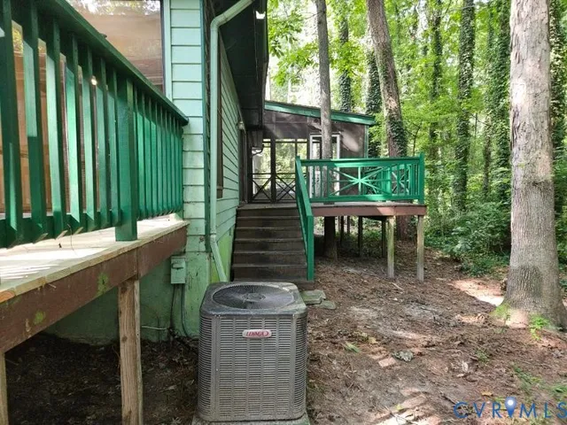 a view of a patio with table and chairs with wooden floor and fence
