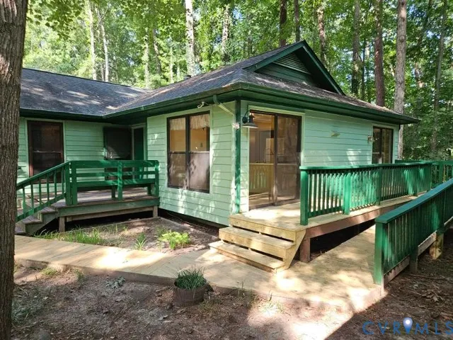 a view of a house with a small yard plants and large tree