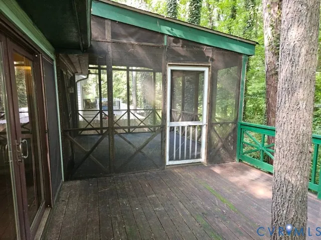 a view of empty room with wooden floor and floor to ceiling window