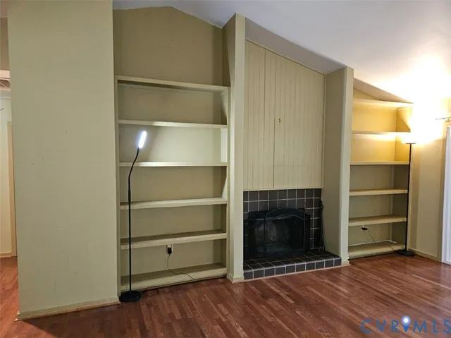 an empty room with chandelier fan