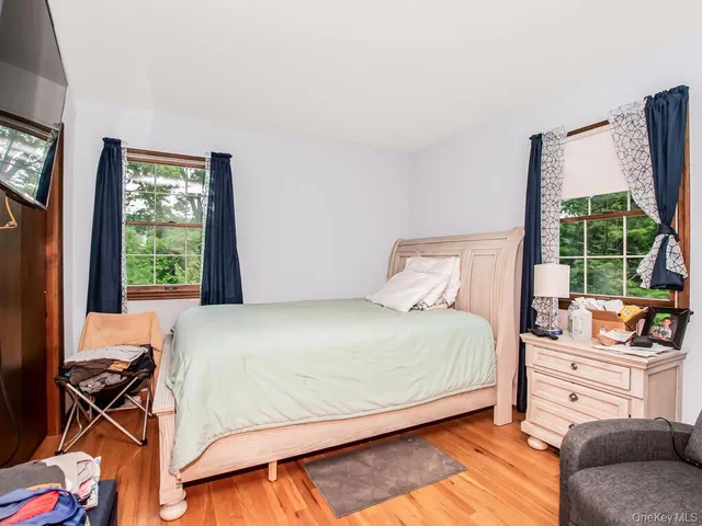 a bedroom with a bed and flat screen tv