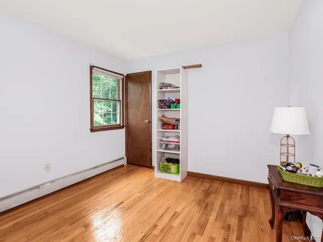 a bedroom with a bed and large windows