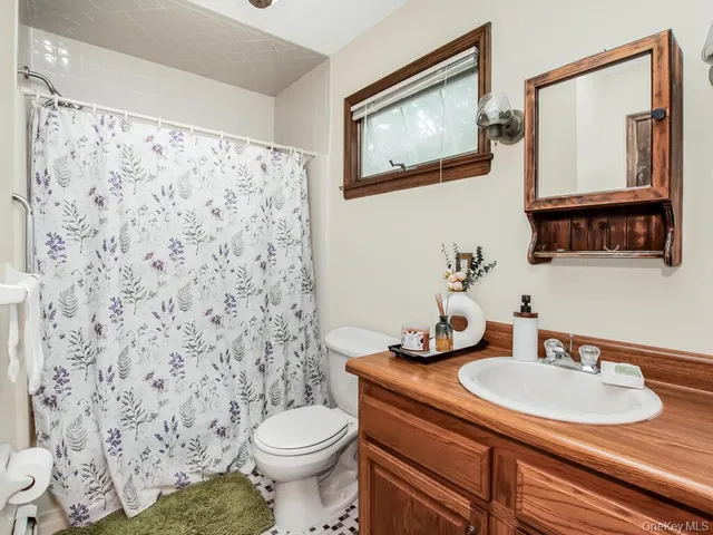 a view of an empty room with a window and workspace