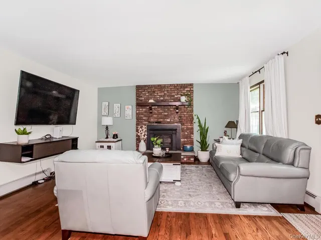 a open kitchen with a refrigerator a stove a sink dishwasher and a dining table with garden view