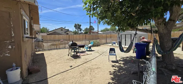a view of a backyard with sitting area and furniture
