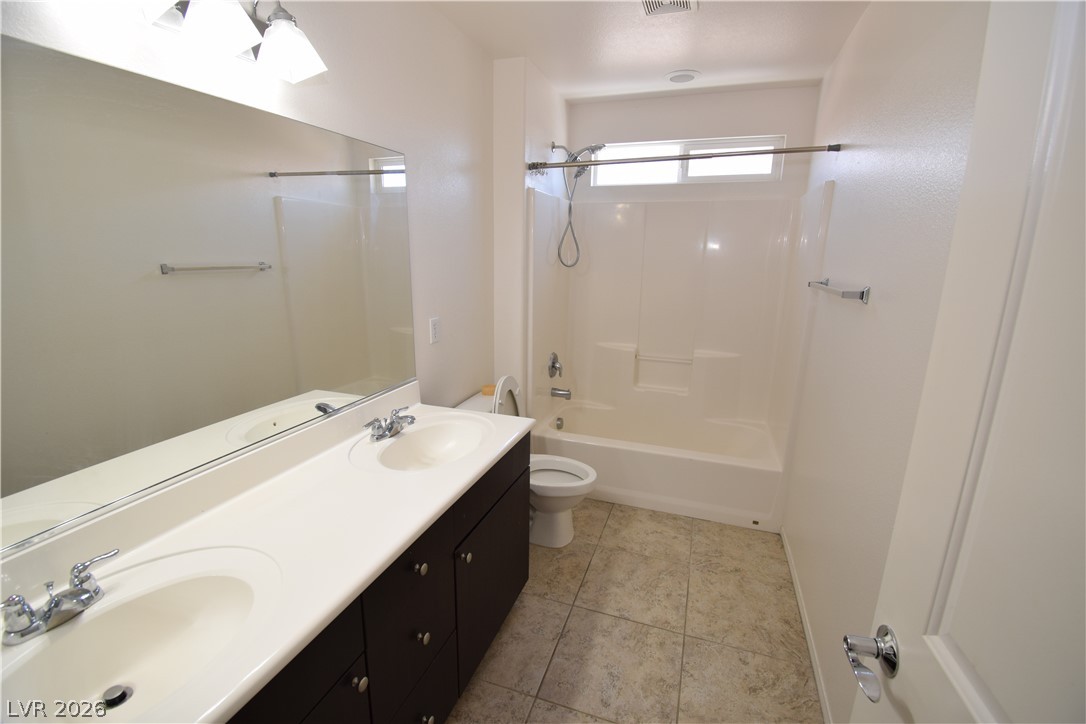 3622 Via Terracina Henderson, NV 89052 - Photo 18 of 22 Dual vanity sinks provide ample space in this well-appointed bath, featuring a combined tub and shower.