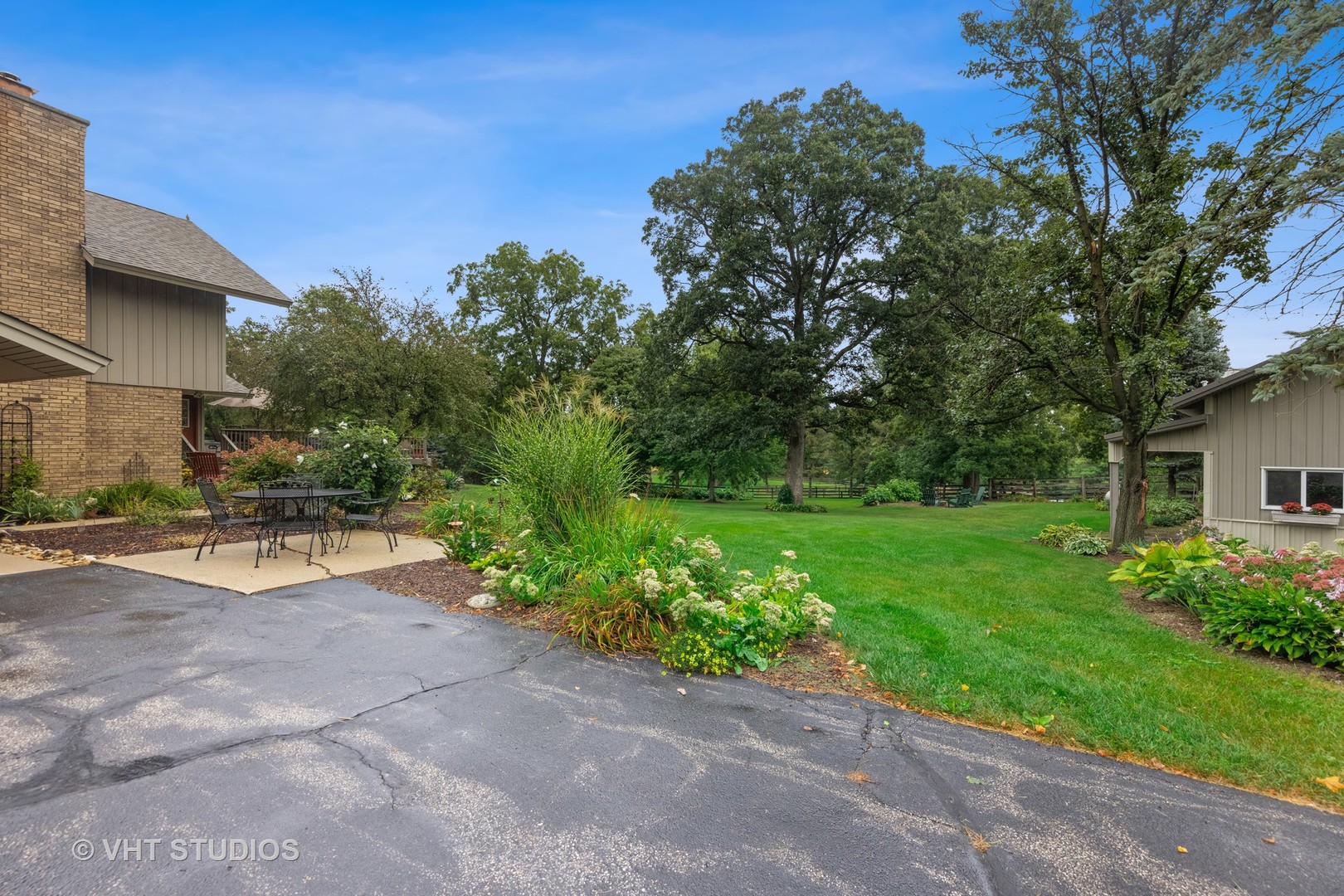 3S557 Norris Road Sugar Grove, IL 60554 - Photo 38 of 46 a view of a patio with plants and a bench with wooden fence