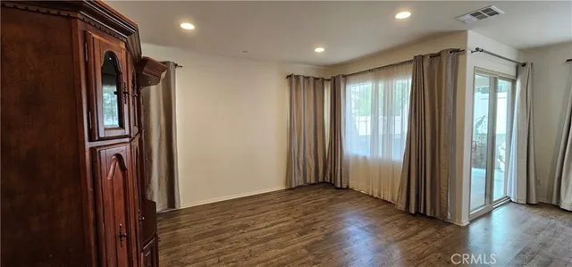 a view of hallway with wooden floor